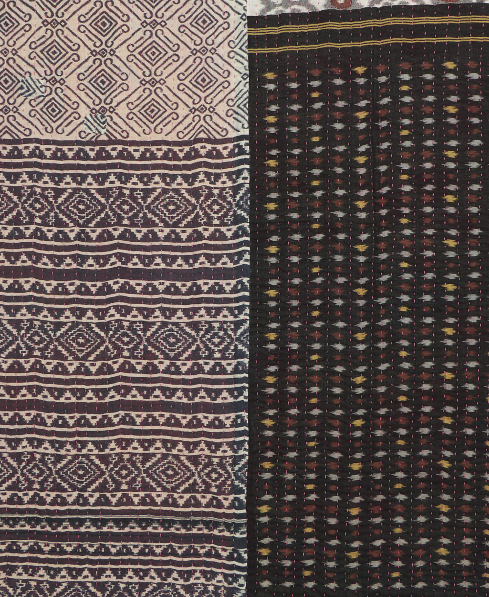 kantha quilt throw with a tag featuring the hand-stitched signature of the maker