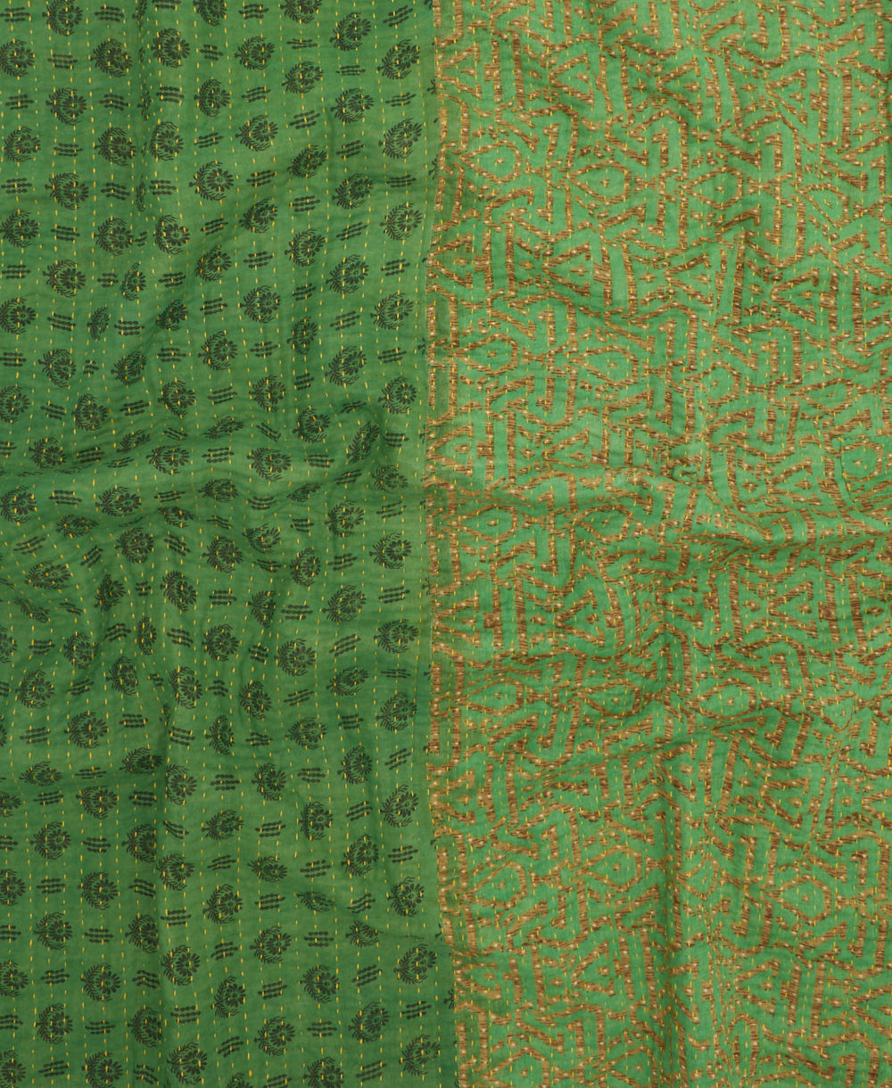 kantha quilt throw with a tag featuring the hand-stitched signature of the maker