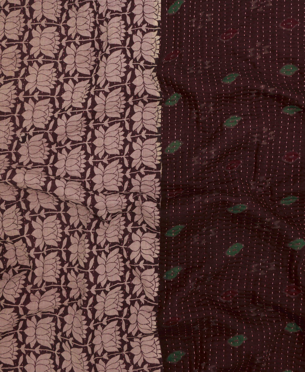 kantha quilt throw with a tag featuring the hand-stitched signature of the maker
