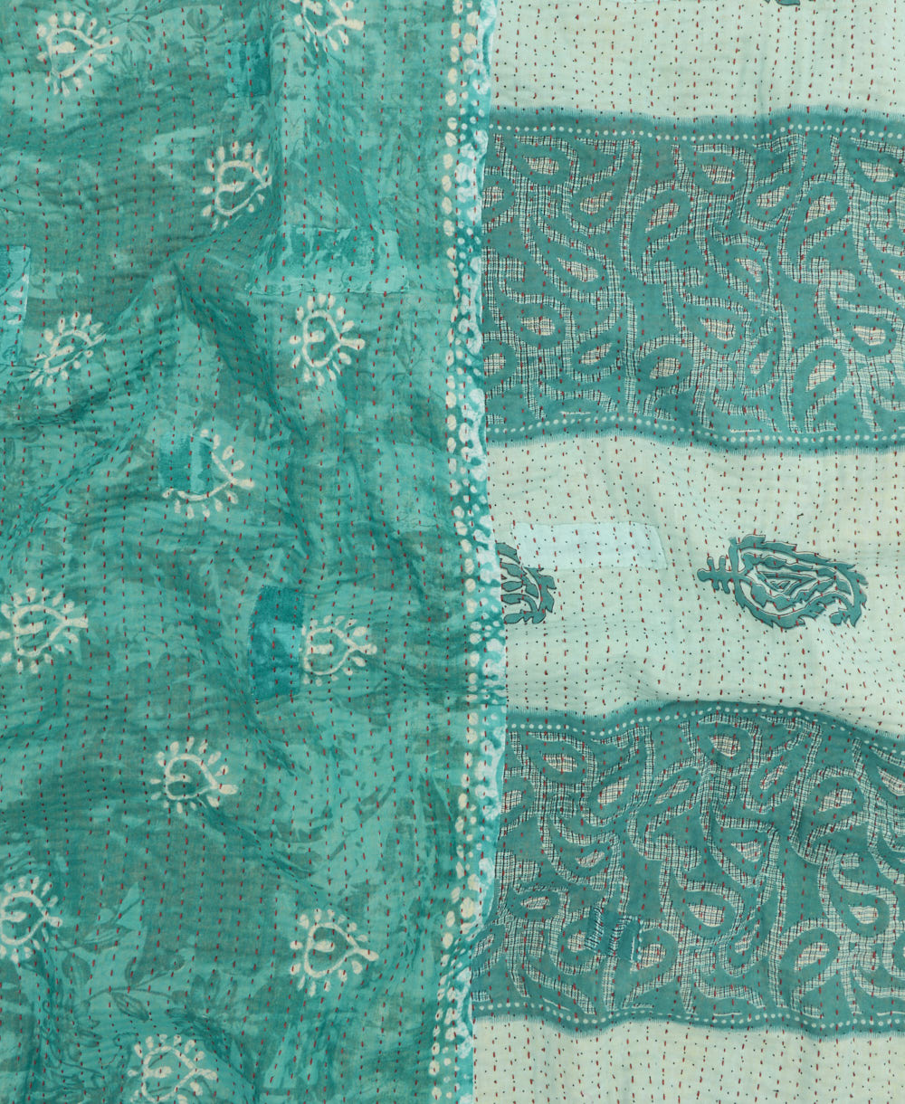 kantha quilt throw with a tag featuring the hand-stitched signature of the maker