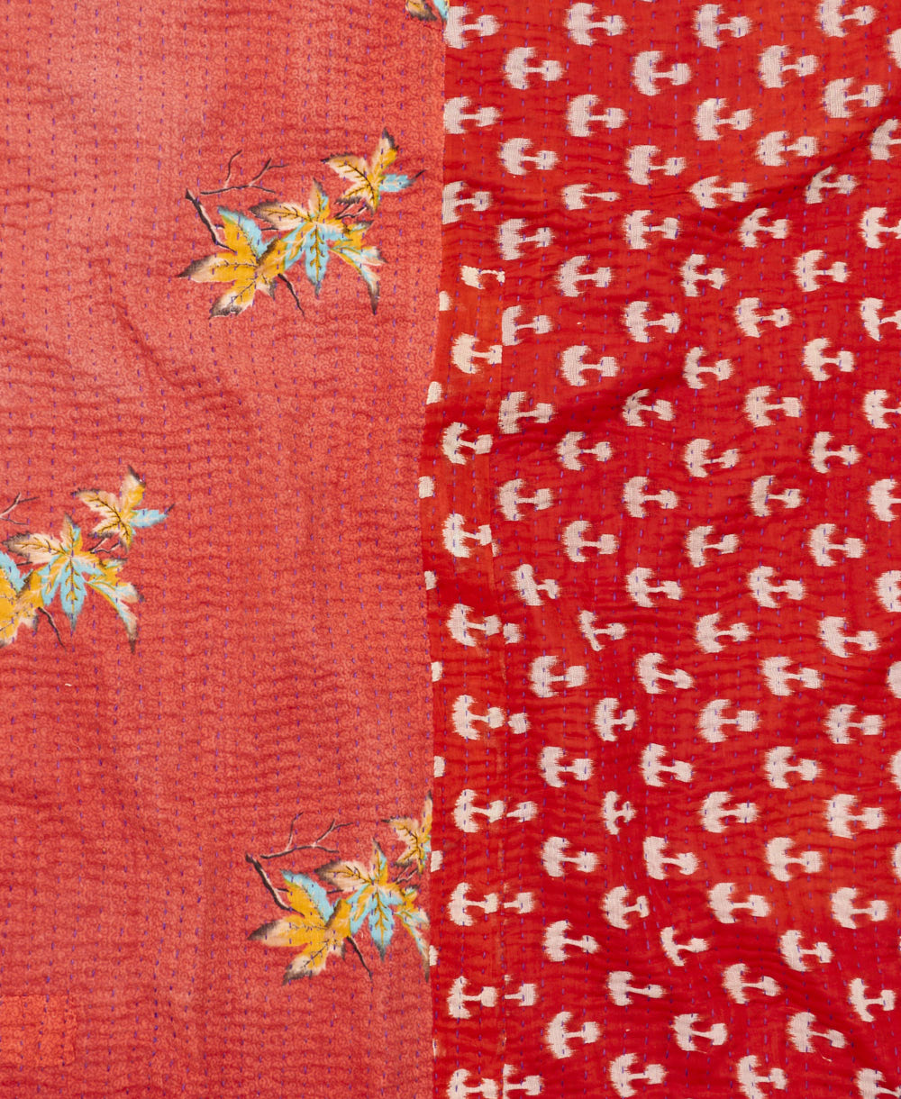 kantha quilt throw with a tag featuring the hand-stitched signature of the maker