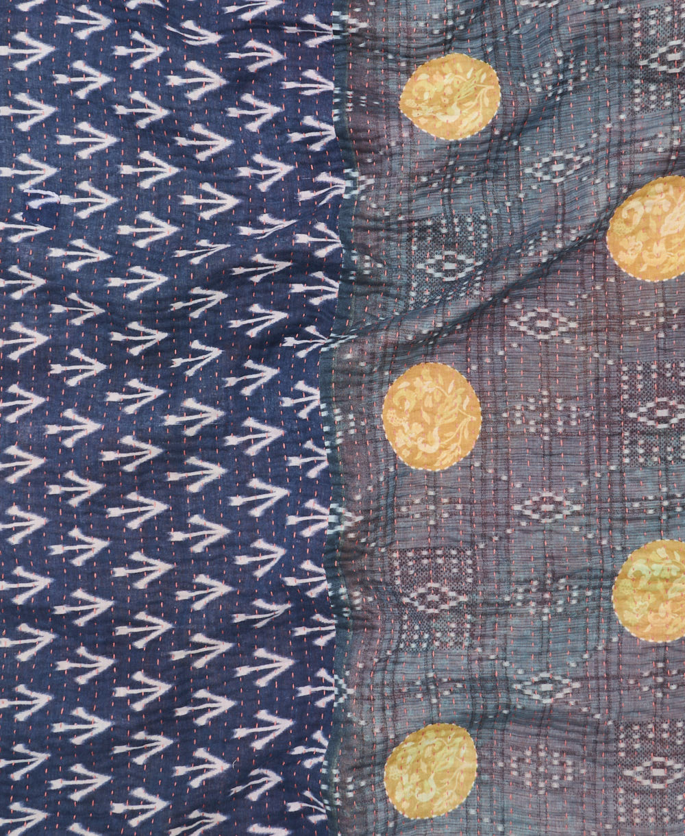 kantha quilt throw with a tag featuring the hand-stitched signature of the maker