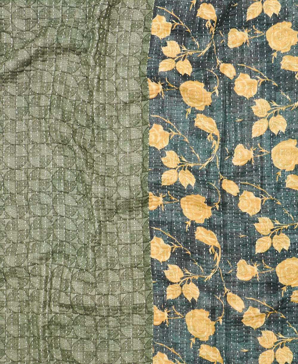 kantha quilt throw with a tag featuring the hand-stitched signature of the maker