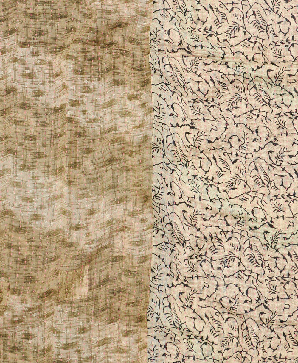 kantha quilt throw with a tag featuring the hand-stitched signature of the maker