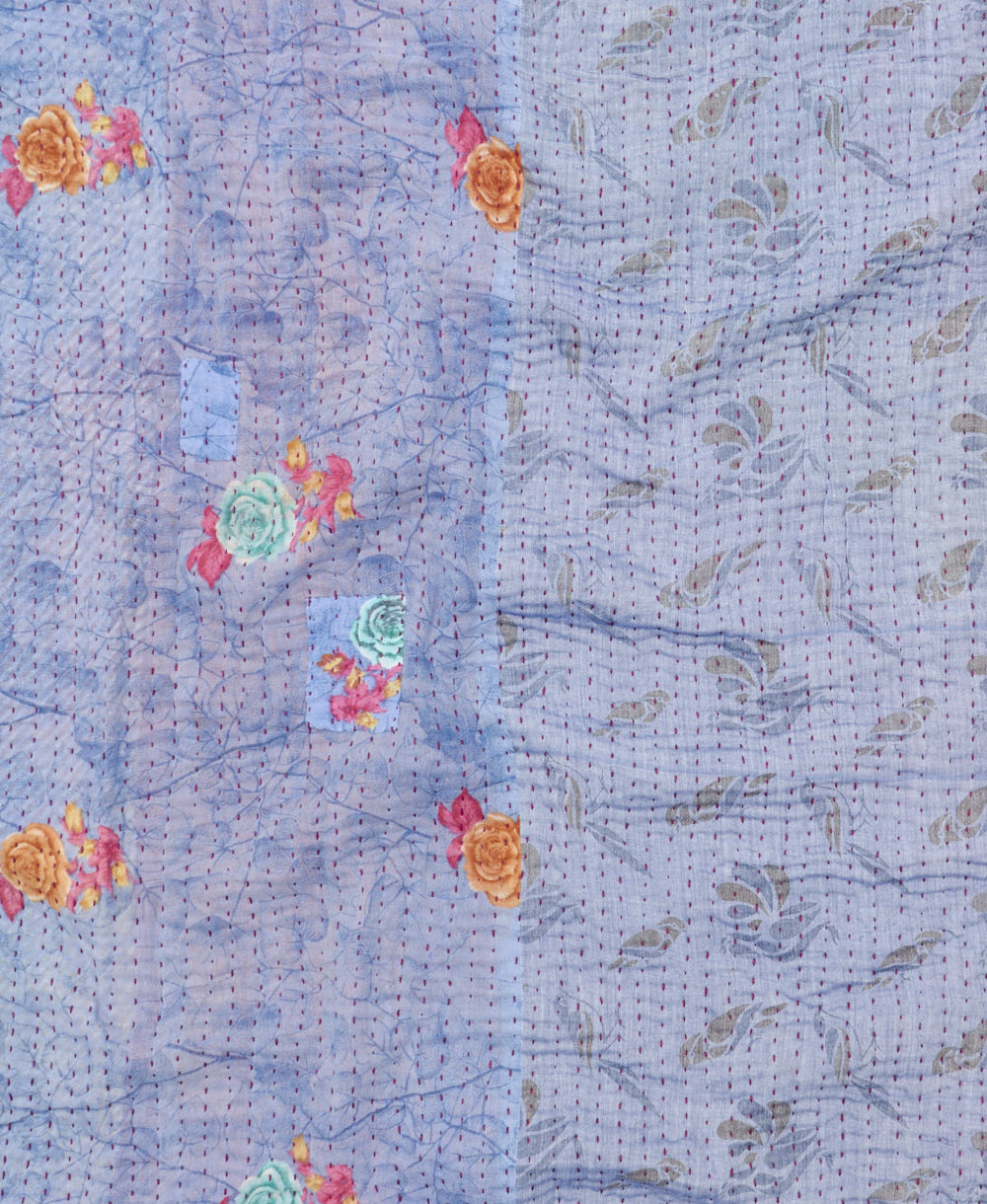 kantha quilt throw with a tag featuring the hand-stitched signature of the maker