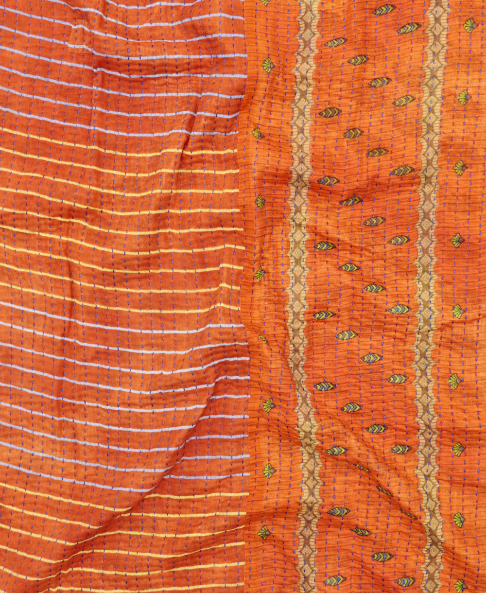 kantha quilt throw with a tag featuring the hand-stitched signature of the maker