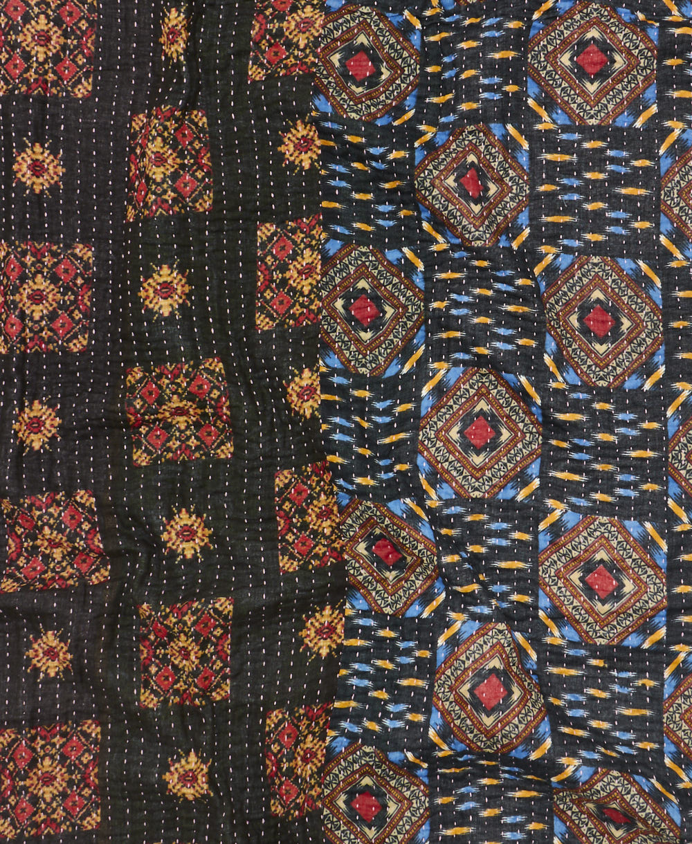 kantha quilt throw with a tag featuring the hand-stitched signature of the maker