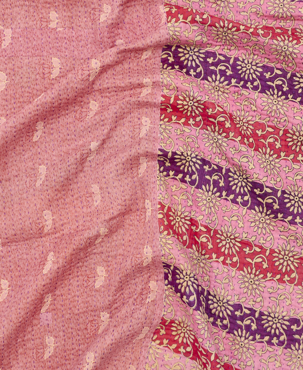 kantha quilt throw with a tag featuring the hand-stitched signature of the maker