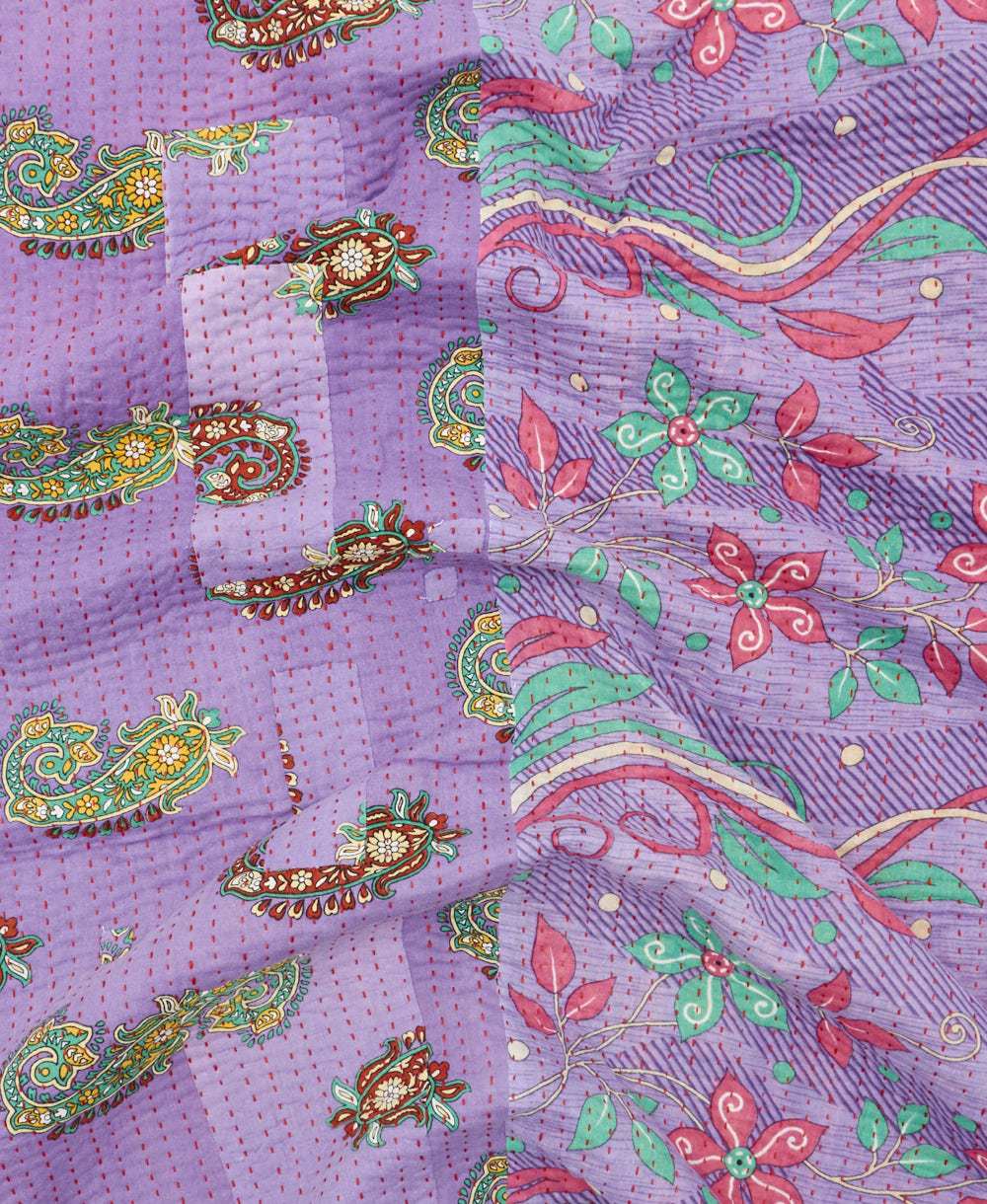 kantha quilt throw with a tag featuring the hand-stitched signature of the maker