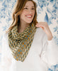 woman smiling in a white sweater with a beige floral vintage kantha square scarf from Anchal tied around her neck