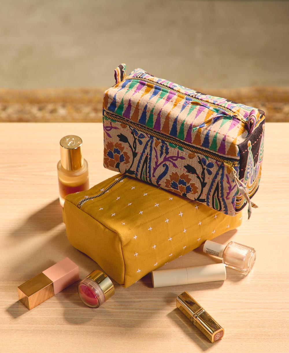 Colorful makeup bag with cosmetics on a wooden surface