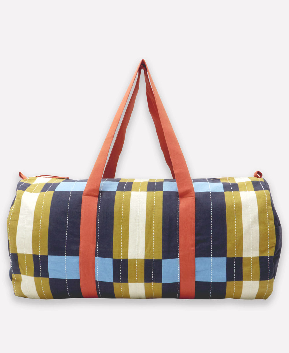 Multicolored checkered bag with red straps on a white background