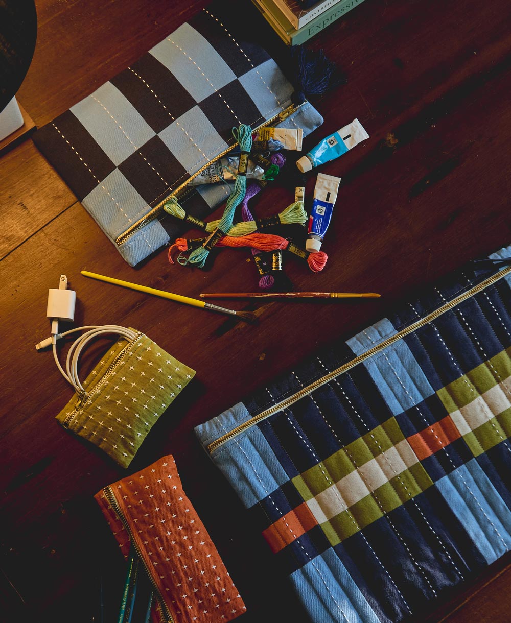 Colorful fabric samples and sewing tools on a wooden surface