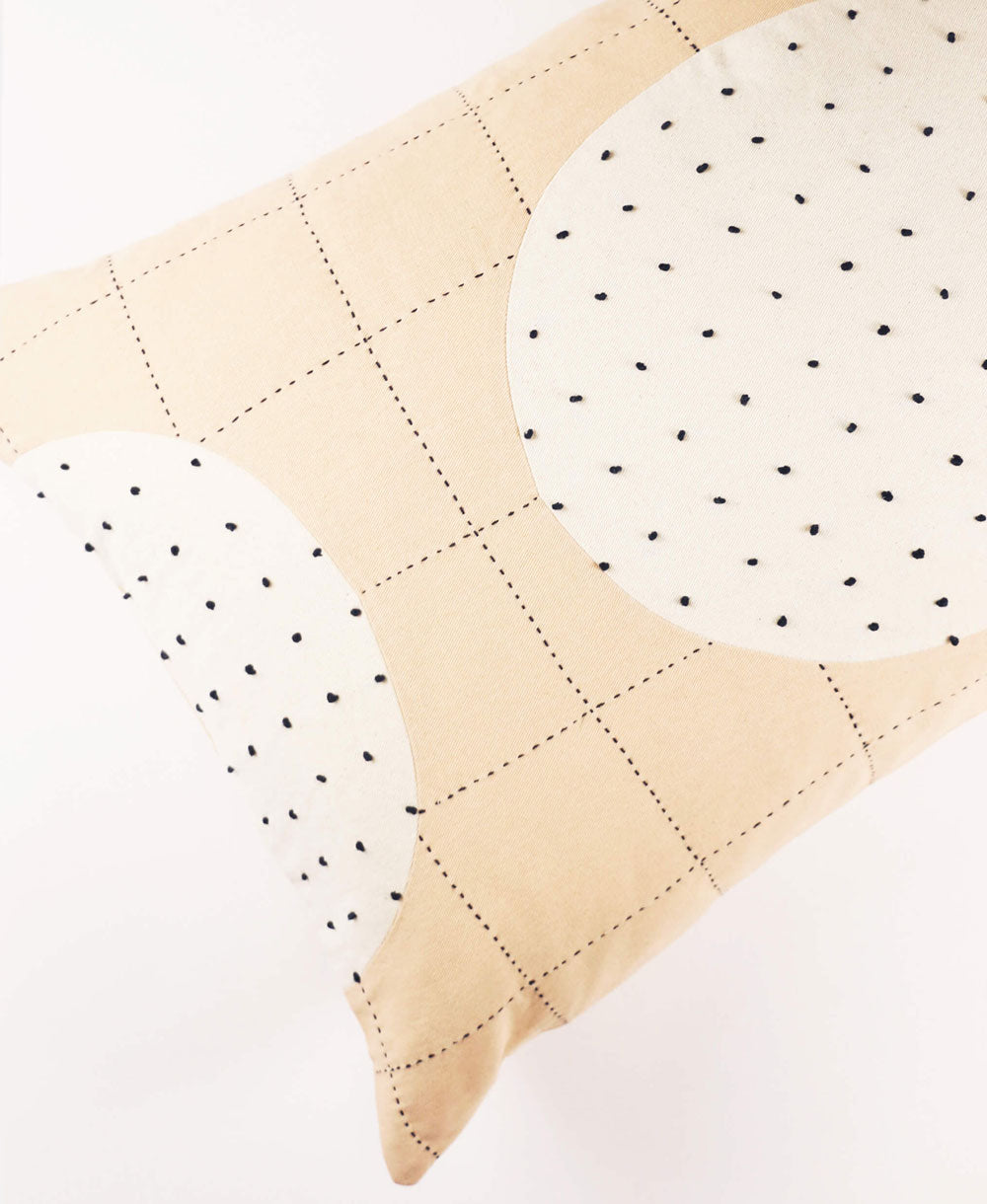 Quilted fabric with beige and white pattern on a white background