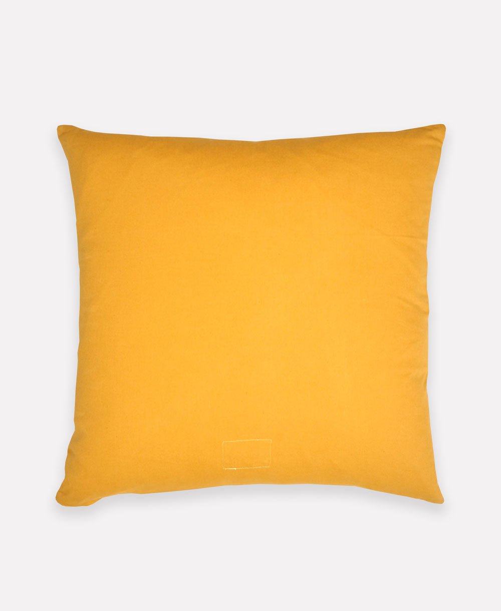 back of mustard yellow throw pillow with colorblock design on the front