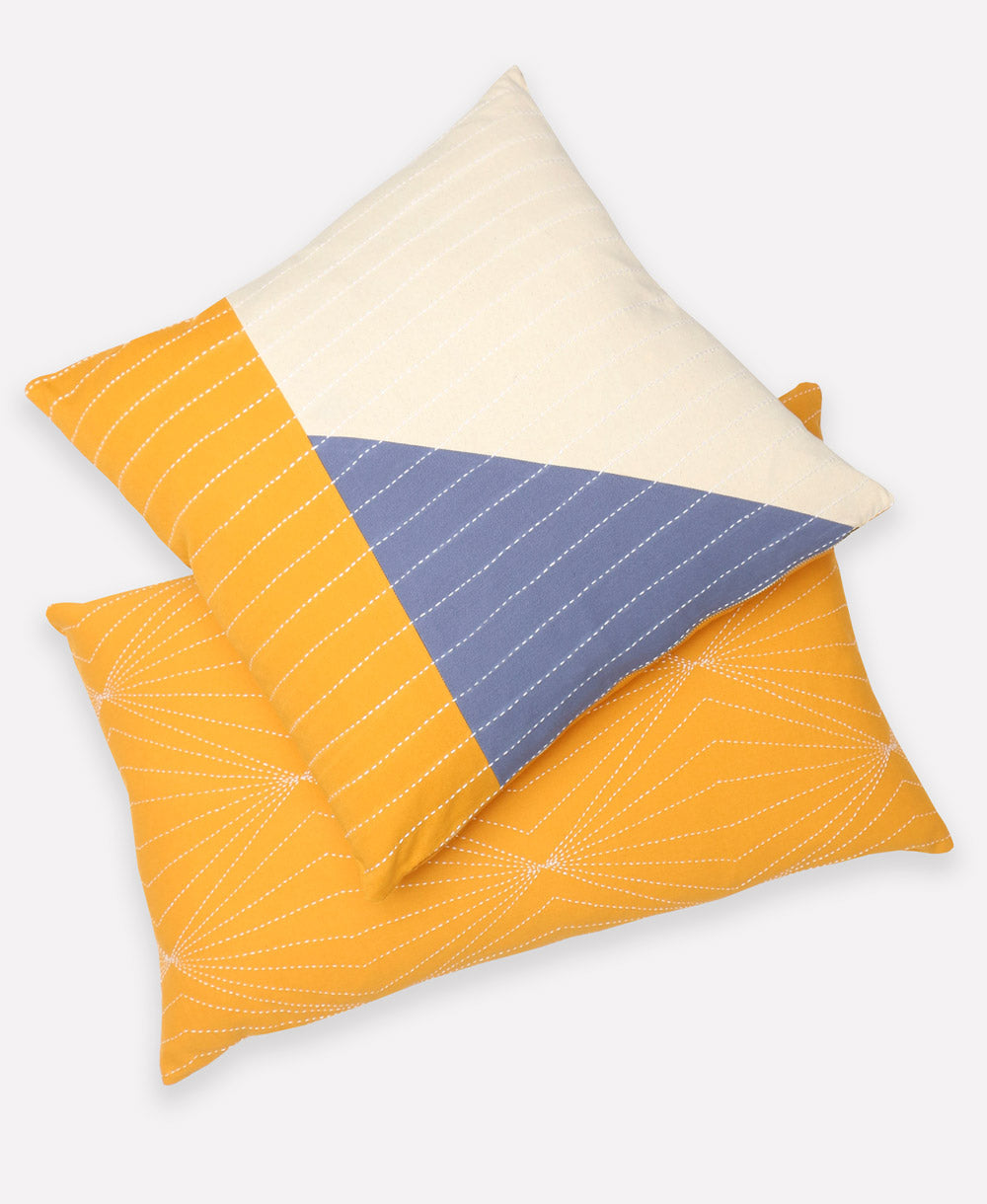 blue and yellow geometric throw pillow paired with matching yellow lumbar throw pillow on white background