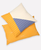 blue and yellow geometric throw pillow paired with matching yellow lumbar throw pillow on white background