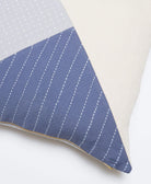 close up of didi colorblock throw pillow with white hand-stitched embroidery