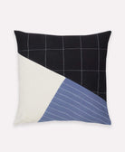 Decorative pillow with black, white, and blue geometric pattern on a white background