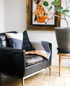 Black leather sofa with decorative pillows in a living room setting