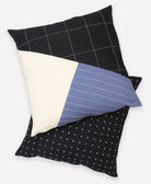 colorblock throw pillow paired with black cross-stitch throw pillow on white background