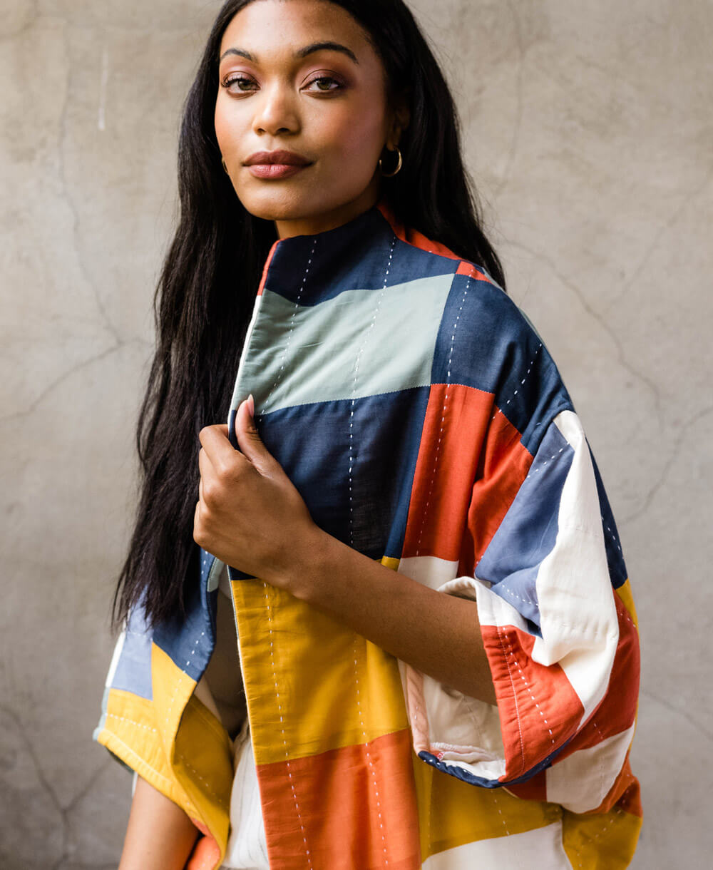 colorful quilted cocoon jacket with vertical white hand-embroidery