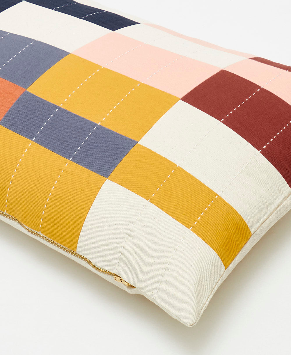 Colorful quilt with a geometric pattern on a white background