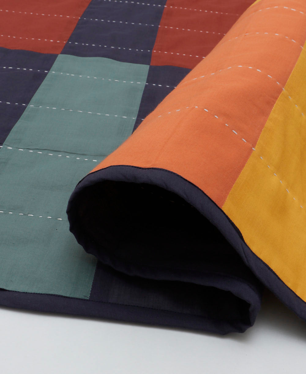 colorful checkered lightweight quilt with white kantha stitching