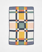 Multicolored checkered quilt blanket on a white background