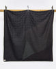 lightweight quilt in black with hand-embroidered stitching made from 100% organic cotton
