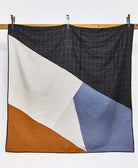 black, white, blue and camel modern patchwork quilt with white embroidery