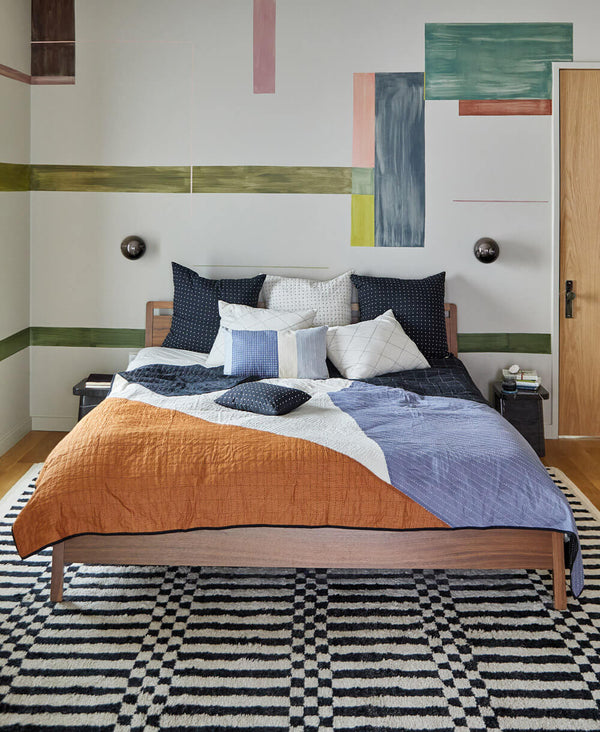 modern quilt by Anchal in bold geometric bedroom with abstract wall mural