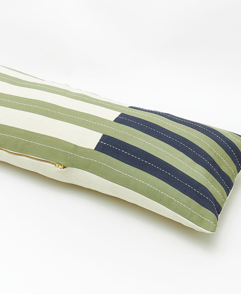 Striped pillow with green and navy pattern on a white background