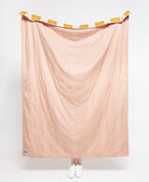 Pink fabric draped over a stand on a white background