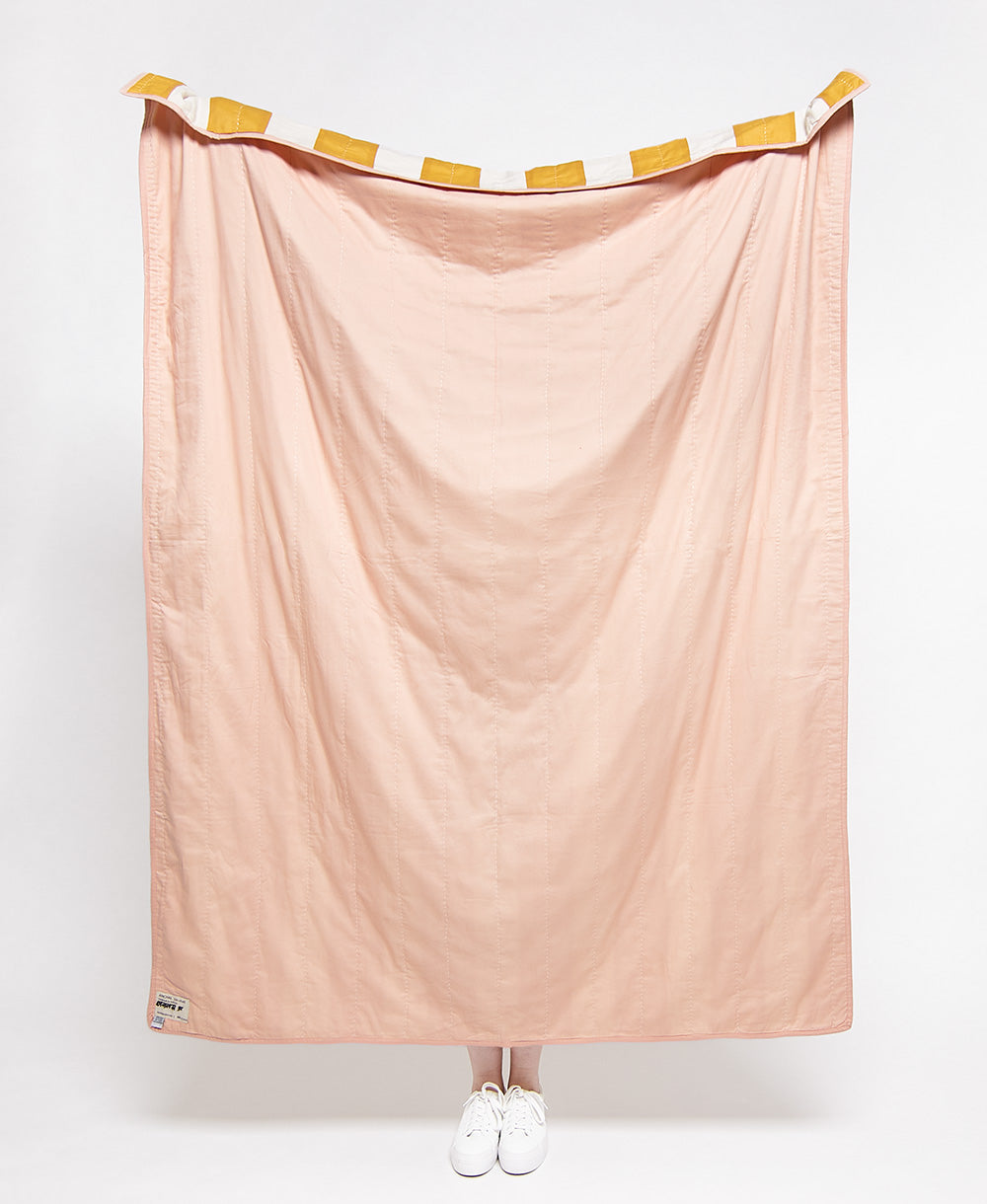 Pink fabric draped over a stand on a white background