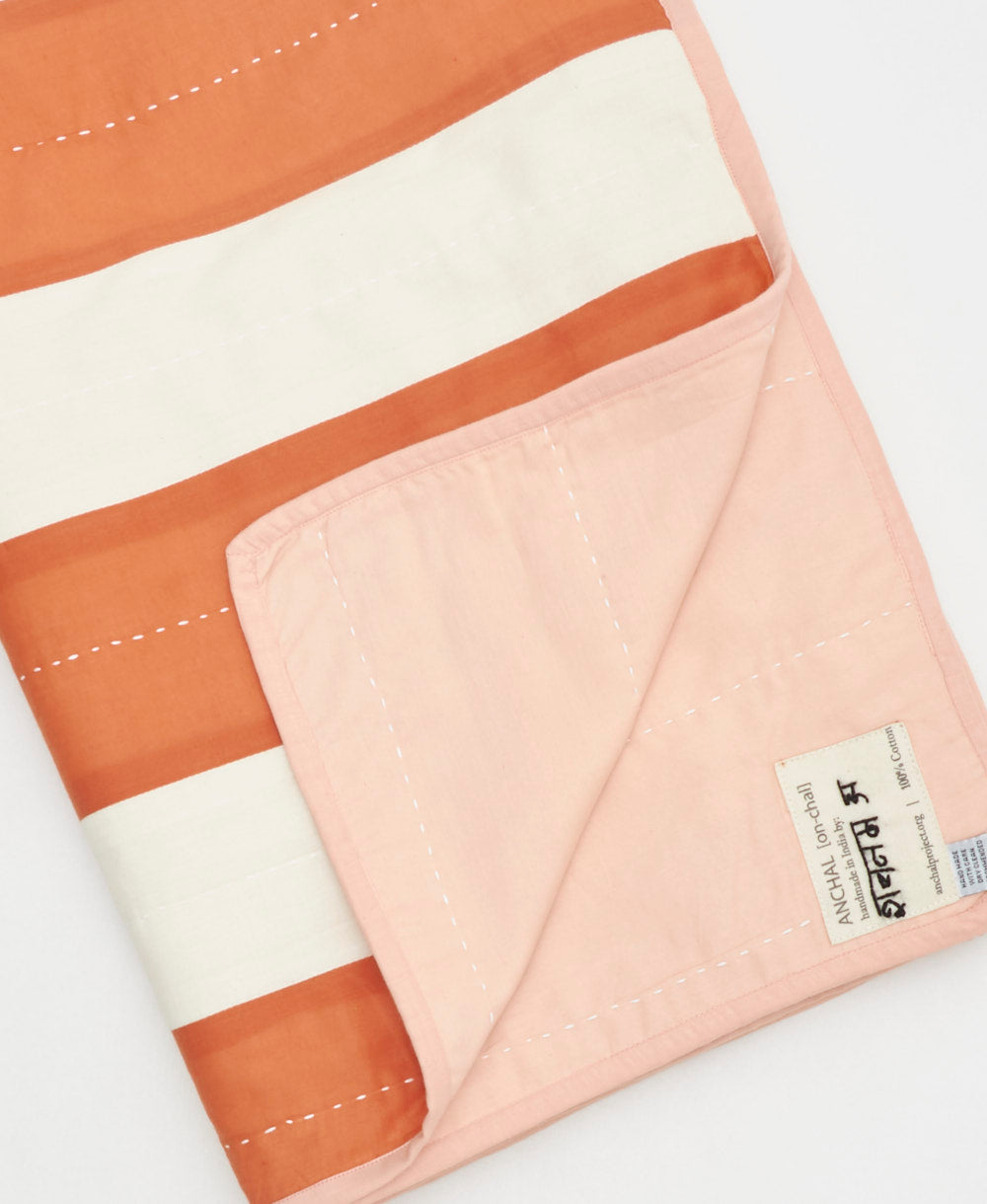 Striped fabric with orange and white stripes on a white background