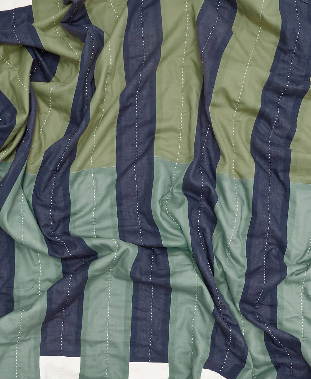 Close-up of green and navy striped fabric with kantha stitching