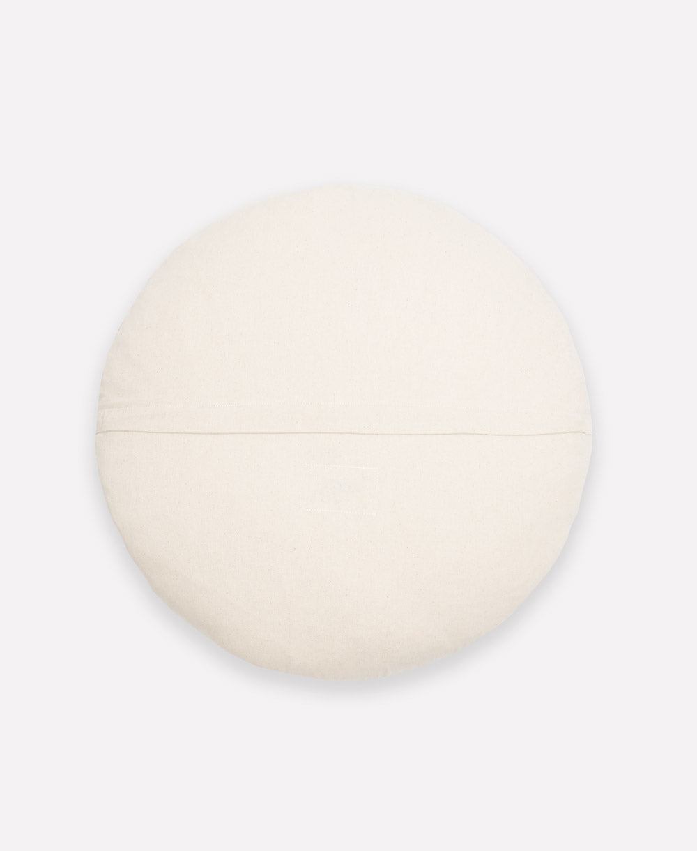 back of offset round pillow in natural white handmade in India from 100% organic cotton