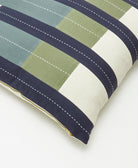 close up of offset throw pillow with brass YKK metal zipper closure
