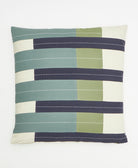 Striped pillow with green, blue, and beige colors on a white background