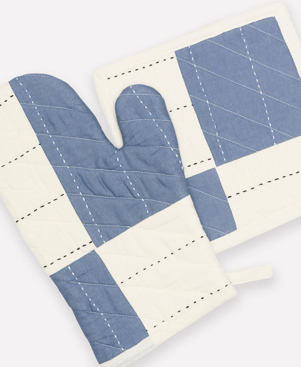 Quilted oven mitt and potholder set with blue and white pattern on a white background
