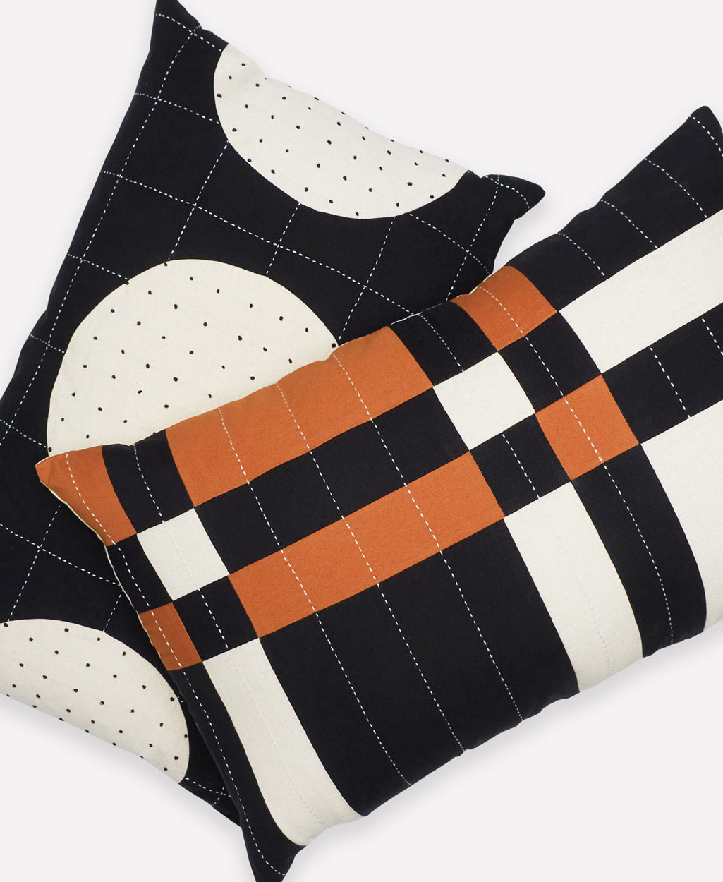 coordinating lumbar throw pillows in black and brown with white kantha embroidery handmade from organic cotton