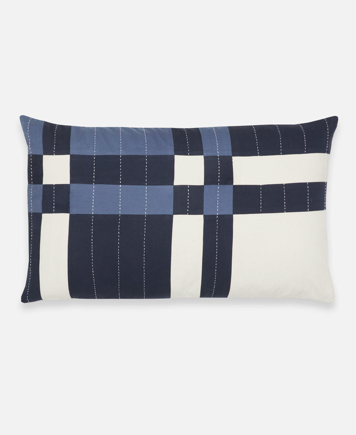 Patchwork pillow with blue and white squares on a white background