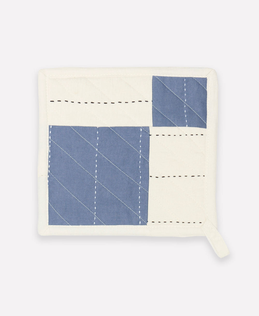 slate blue and white quilted pot holder with black embroidery