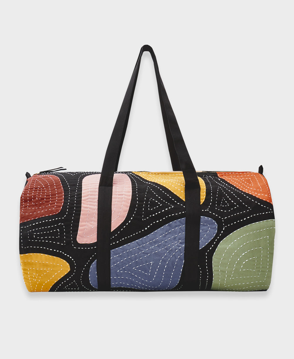 canvas duffle bag in black with colorful patchwork design and white hand-stitched embroidery