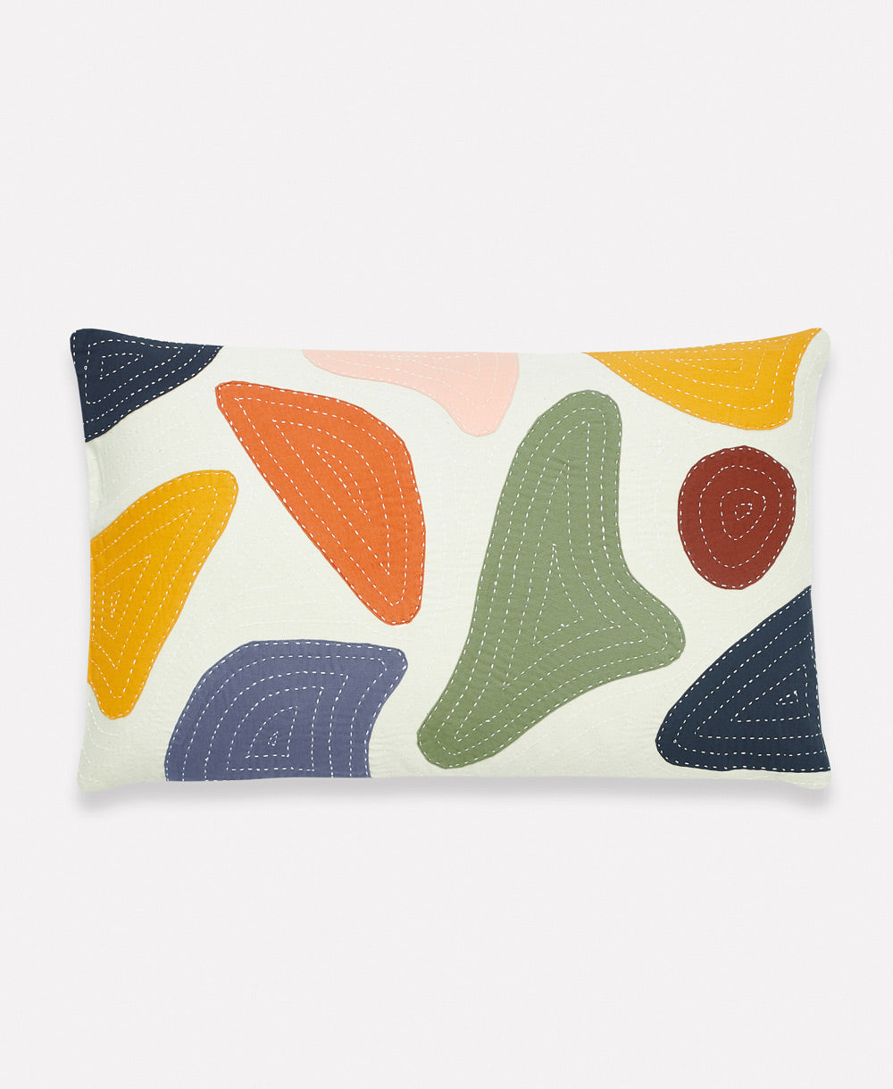 Decorative pillow with abstract colorful shapes on a white background