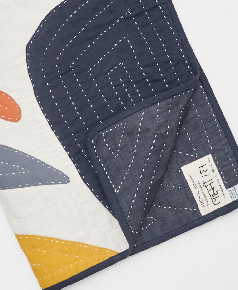 Quilt with geometric patterns on a white background