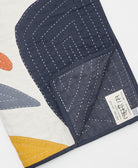 Quilt with geometric patterns on a white background