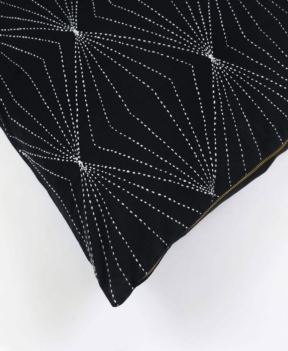 black throw pillow with white kantha embroidery with brass exposed metal zipper
