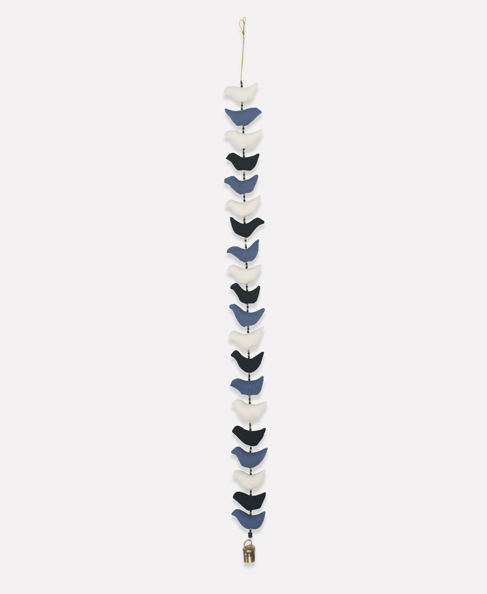 Decorative hanging with blue and white birds on a white background